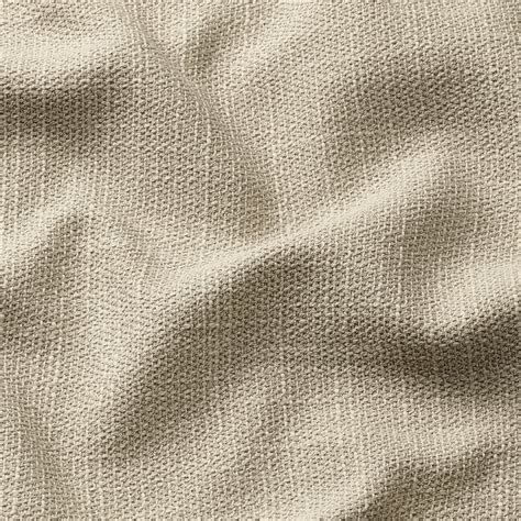 Primo piano su una texture di tessuto color beige con variazioni cromatiche sottili