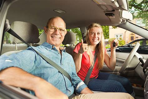 Image illustrating a young driver with a parent in a car