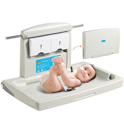 A baby happily on a changing table