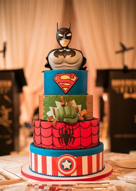Torta decorata con simboli di supereroi e pupazzetti iconici
