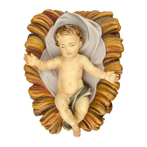 immagine di un piccolo Gesù bambino realizzato in stoffa e legno pronto per la culla