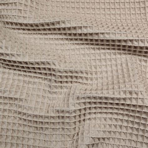 dettaglio macro del tessuto in cotone biologico e della struttura a nido d'ape sottostante